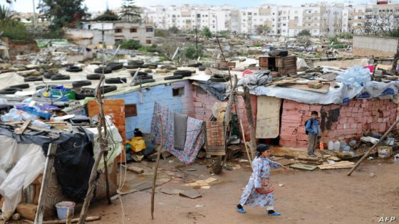 TO GO WITH AFP STORY BY GUILLAUME KLEIN
A Moroccan woman walks past homes in the Sahb al-Kaid shanty town in Sale, northwestern Morocco, on the right bank of the Bou Regreg river, opposite the national capital Rabat, for which it serves as a commuter town, on November 28, 2012. If the sea is never far, it is the ocean of tarpaulins and sheet steel that suddenly hits our eyes. Under the autumnal sky, residents of Sahb al-Kaid are still waiting to be relocated. AFP PHOTO/FADEL SENNA / AFP PHOTO / FADEL SENNA