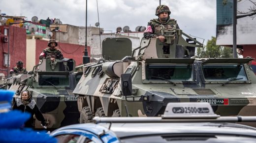 Moroccan military armoured personnel carriers (APC) patrol a street, instructing people to remain at home, in the capital Rabat on March 22, 2020. - A public health state of emergency went into effect in the Muslim-majority country late on March 20, and security forces and the army have been deployed on the streets to combat the spread of COVID-19 coronavirus disease. People have been ordered to stay at home, and restrictions on public transport and travel between cities are also in place. (Photo by FADEL SENNA / AFP) (Photo by FADEL SENNA/AFP via Getty Images)
